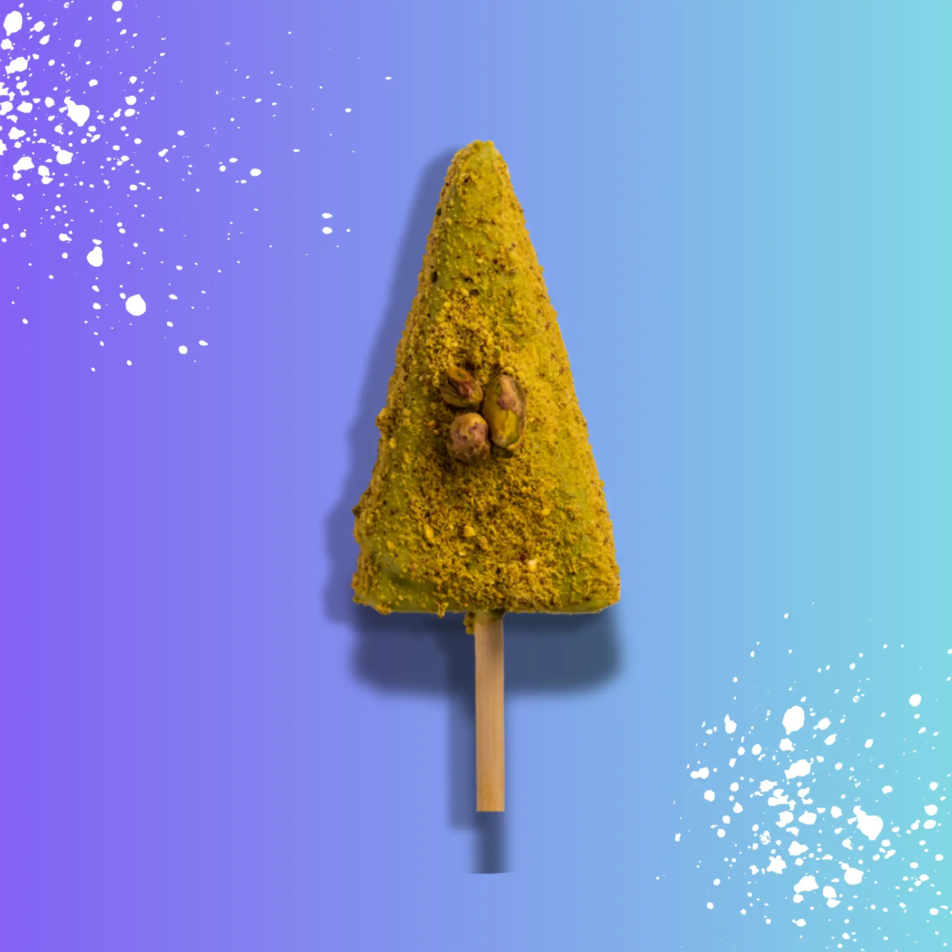 White-chocolate-dipped cheesecake stick coated in crushed pistachios with a pistachio sauce drizzle