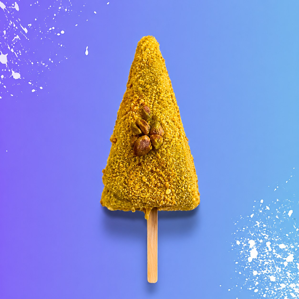 White-chocolate-dipped cheesecake stick coated in crushed pistachios with a pistachio sauce drizzle