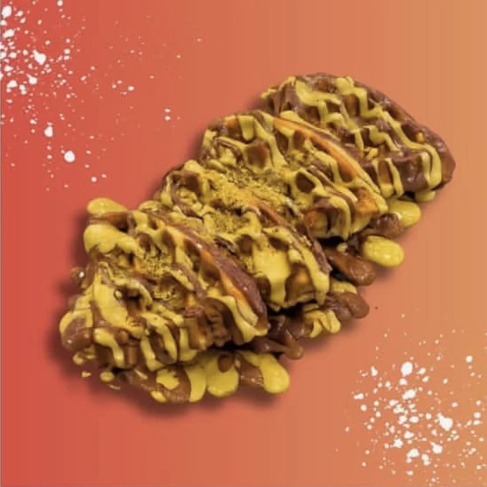 Loaded waffle pieces drizzled with chocolate and pistachio sauce, dusted with pistachio crumb